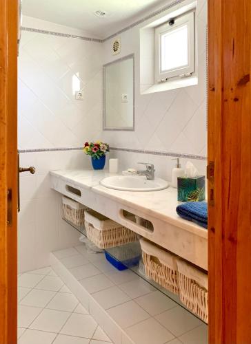a bathroom with a sink and a mirror at LOTUS VILLA 2, ALBUFEIRA in Albufeira