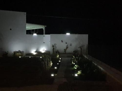 a backyard at night with lights in the dark at Tramonto Luxury Villa No1- Breathtaking sunset view in Karpathos Town
