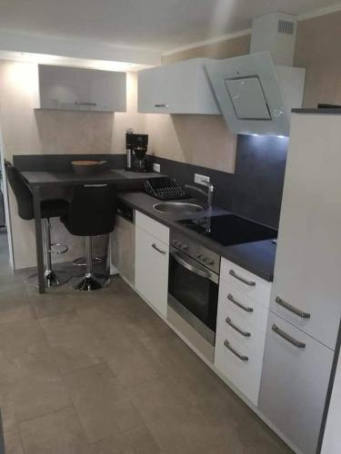 a kitchen with a black counter top and a sink at Ferienwohnung Klockenhagen 2 in Ribnitz-Damgarten