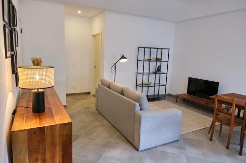 a living room with a couch and a table at Casas do Mercado - Casa Sirius in Angra do Heroísmo