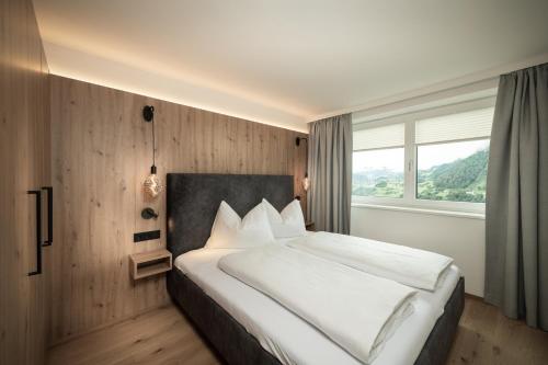 a bedroom with a large bed with a large window at Appartement Alpenrot in Sankt Johann im Pongau