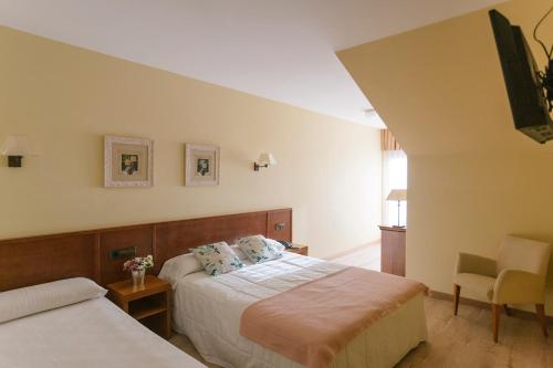 Ένα ή περισσότερα κρεβάτια σε δωμάτιο στο Hotel O Castro