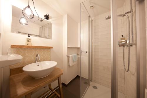 a white bathroom with a sink and a shower at Der Tannenhof in Reutte