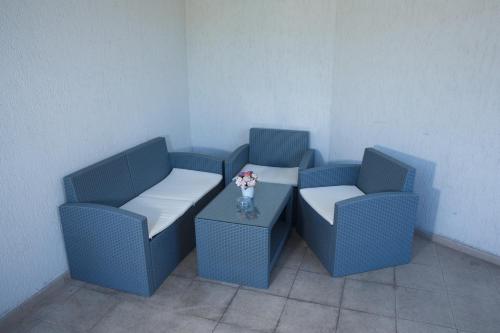 two blue chairs with a vase of flowers on a table at Spa Hotel Kleptuza in Velingrad
