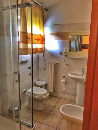a bathroom with a toilet and a sink at Hotel Belvedere Tonara in Tonara