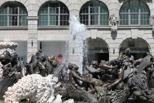 a statue in front of a building with a fountain at Garden Hotel in Nürnberg