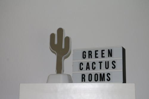 a cactus and a sign on top of a shelf at Green Cactus Rooms - unique and cozy house in Senta