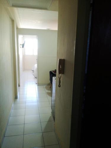 a hallway of a room with a door and a window at Departamento centrico sobre calle principal in San Miguel de Tucumán
