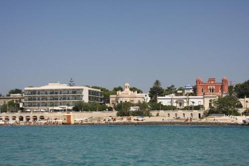a view of a beach and buildings from the water at Villa La Meridiana - Caroli Hotels in Leuca