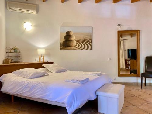 a bedroom with a bed with three stacked rocks on it at Fabulous Rustic Villa Set On Mountain With Unique Views in Valldemossa