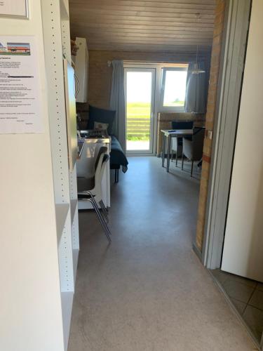 a hallway leading to a kitchen and a dining room at Danhostel Fjaltring in Fjaltring