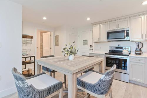 a kitchen with a wooden table and chairs at Harbortown Suites in Plymouth