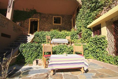 a table and chairs sitting on a patio at Hotel Igoudar Armed in Imlil