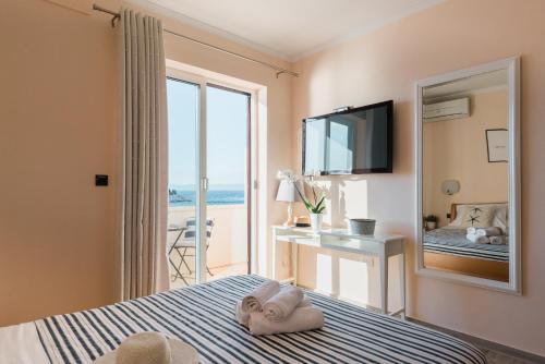 a bedroom with a bed with a view of the ocean at Accommodation Triton in Lastovo