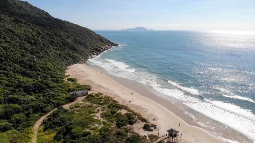 an aerial view of a beach next to the ocean at Villa Giardino - Condomínio de Frente para o Mar - Piscina, Quadra Esportiva, Churrasqueira - 5 Pessoas in Florianópolis