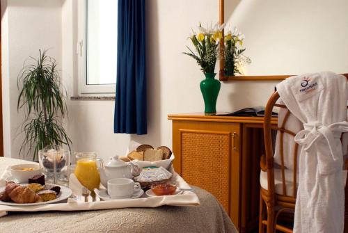 a table with a tray of breakfast food on it at Hotel Terme Villa Teresa in Ischia