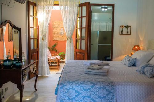 a bedroom with a bed and a dresser and a mirror at Pousada Conceito in São Sebastião