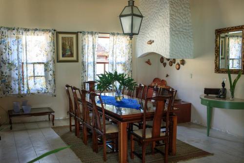 a dining room with a wooden table and chairs at Pousada Conceito in São Sebastião