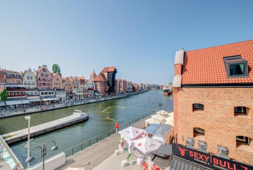 a view of a river in a city at The Black Crane Apartment in Gdańsk
