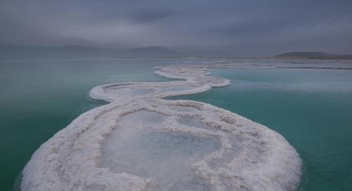 an aerial view of snow covered islands in the ocean at Vastu Dead Sea apartment in Arad