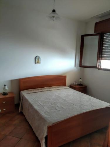 a bedroom with a bed and a mirror and a window at Vacanze Porto Cesareo Salento in Torre Lapillo