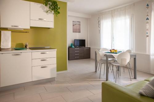 a kitchen and dining room with a table and chairs at Residence Sunrise in Cesenatico