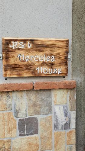 a wooden sign on the side of a building at Hercules House - Il riposo degli Eroi in Ercolano