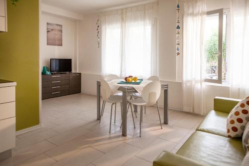 a kitchen and living room with a table and chairs at Residence Sunrise in Cesenatico