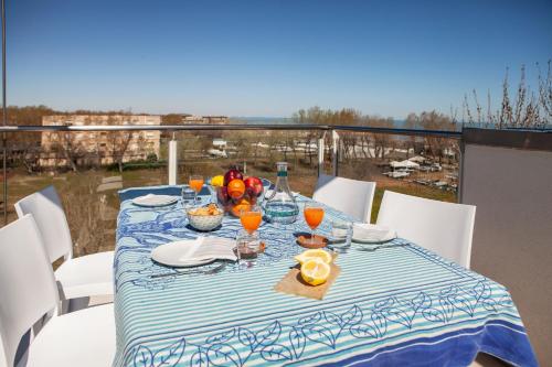 a table with a blue and white table cloth on a balcony at Residence Sunrise in Cesenatico