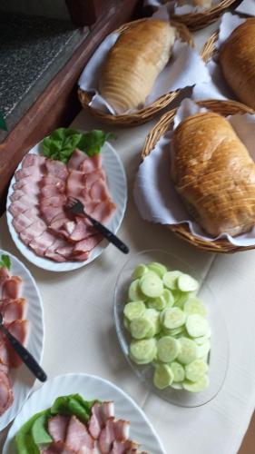 a table topped with plates of different types of food at Holiday Ozon in Sztutowo