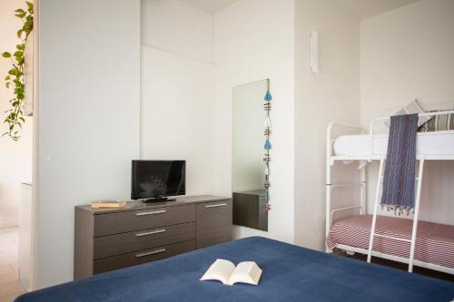 a bedroom with a bed and a bunk bed at Residence Sunrise in Cesenatico