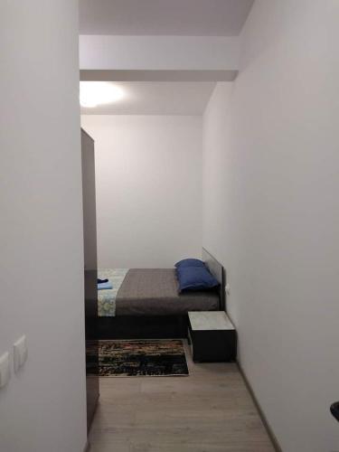 a bedroom with a bed in a white wall at Casa KIM in Eforie Nord
