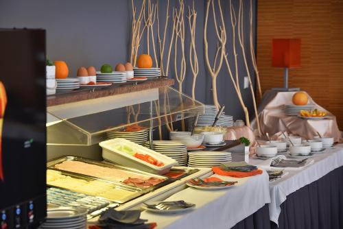 a buffet line with plates and food on tables at Omnia Hotel Relax & Wellness in Janske Lazne