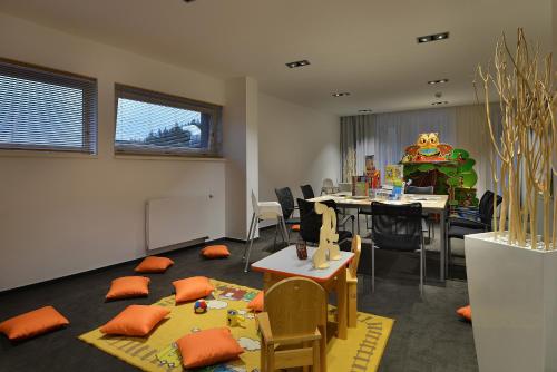 a room with a classroom with chairs and a table at Omnia Hotel Relax & Wellness in Janske Lazne