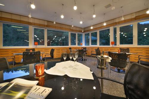 a restaurant with two tables and chairs with wine glasses at Omnia Hotel Relax & Wellness in Janske Lazne
