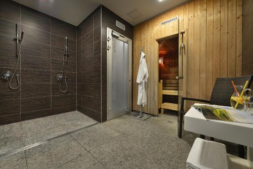 a bathroom with a shower and a sink at Omnia Hotel Relax & Wellness in Janske Lazne