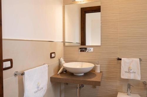 a bathroom with a sink and a mirror at TERRA TERRA - Masseria Minunni in Conversano