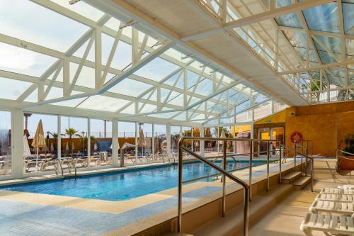 a large swimming pool with a glass ceiling at Gran Hotel Peñiscola in Peñíscola