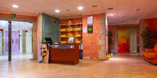 a lobby of a store with a dog on the counter at Gran Hotel Peñiscola in Peñíscola
