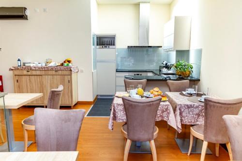 a kitchen and dining room with a table and chairs at Boutique Mouras in Mondim de Basto