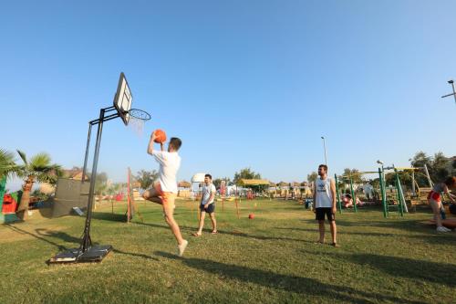 a group of people playing a game of basketball at Unluselek Hotel in Anamur