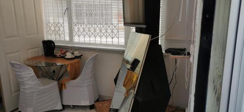 a room with a table and a window and a table at Lytton Cresent B&B in Pinetown