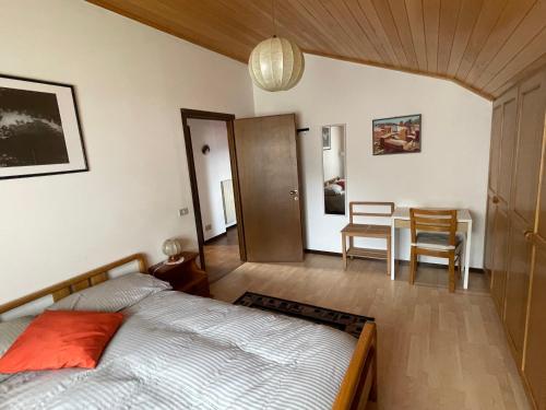 a bedroom with a bed and a table and chairs at Casa Dolce Casa in Tirano