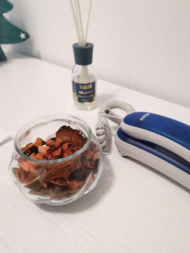 a bowl of food on a counter next to a phone at Hotel Costa in Bari