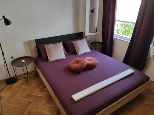 a bed with two pillows on top of it at Apartment Sky Central in Makarska