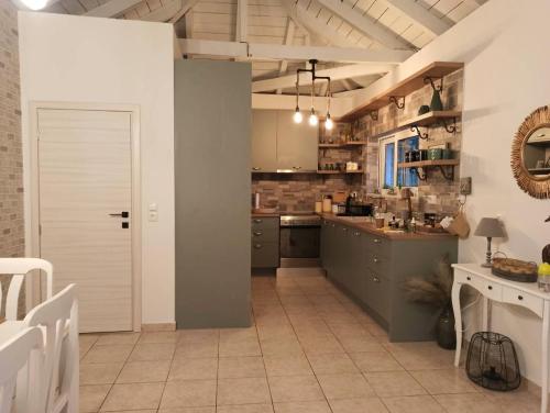a large kitchen with a white door and a counter at Ktima Karamouzis in Petalidhion