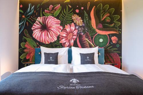 a bedroom with a bed with a floral wall at Residenz Styrian Toskana Splendid in Bad Gleichenberg