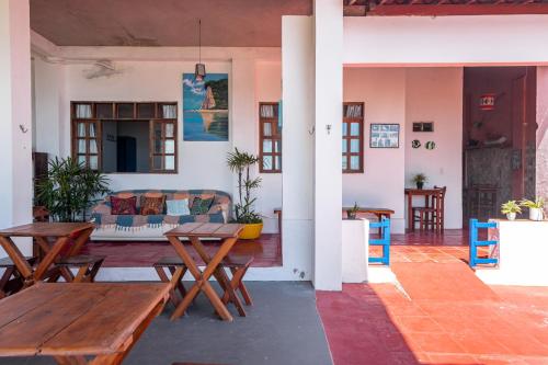 a living room with wooden tables and a couch at casa Mirage Pipa , apartamentos in Pipa