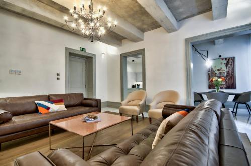 a living room with a couch and a table at 10 Strait Street Apartments in Valletta