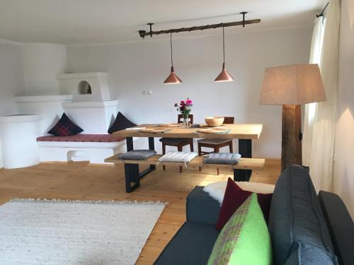 a living room with a table and a couch at Apartment Der Riese in Reith bei Seefeld